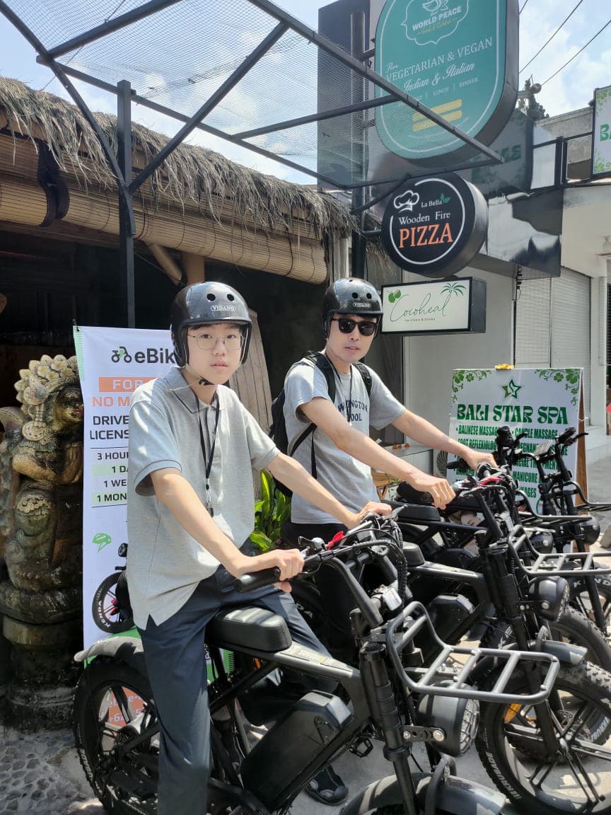 Customer posing with a delivered e-bike in Bali